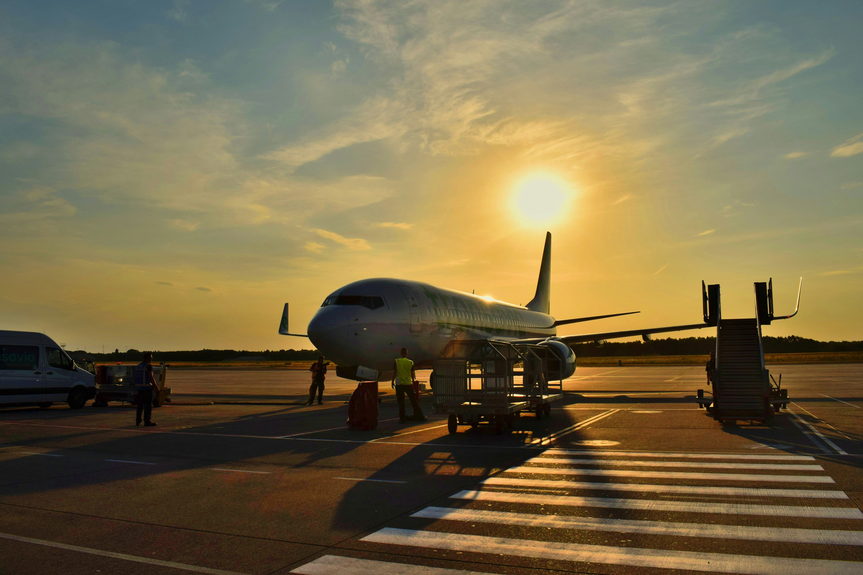 Transport van on airport tarmac with private jet.